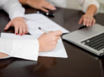 Hands at computer doing trial prep