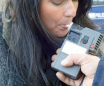 Woman Taking Breathalyzer Test