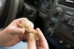 Man Rolling Marijuana Joint in Driver's Seat of Car